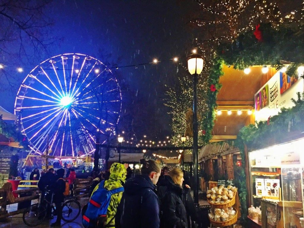 A ferris wheel lit up at night at an Oslo, Norway Christmas market