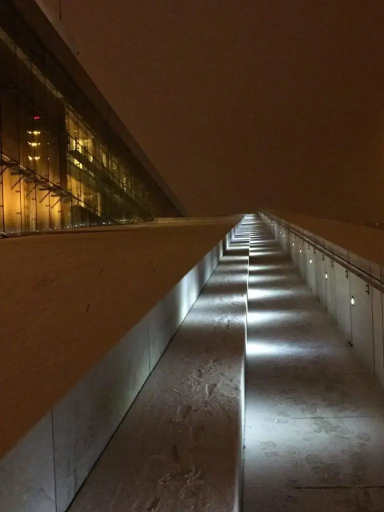 Pathway leading up the side of the Oslo Opera House lit up at night