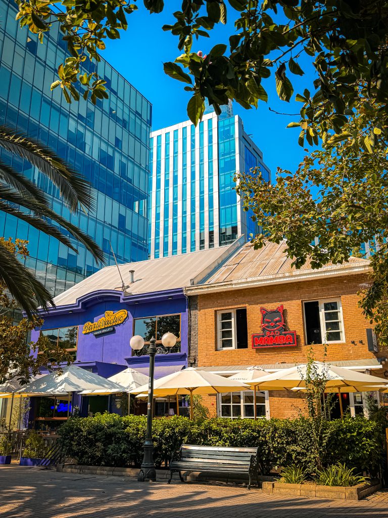 Colorful brick restaurants in front of modern skyscrapers