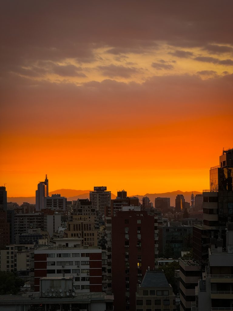 Glowing sunset with silhouette of Santiago Chile buildings