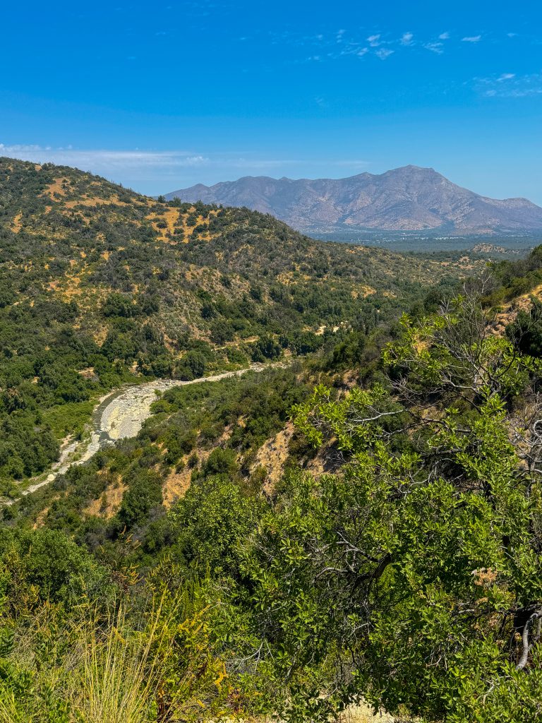 View point of the valley and distant mountains in Parque Nacional Rio Clarillo