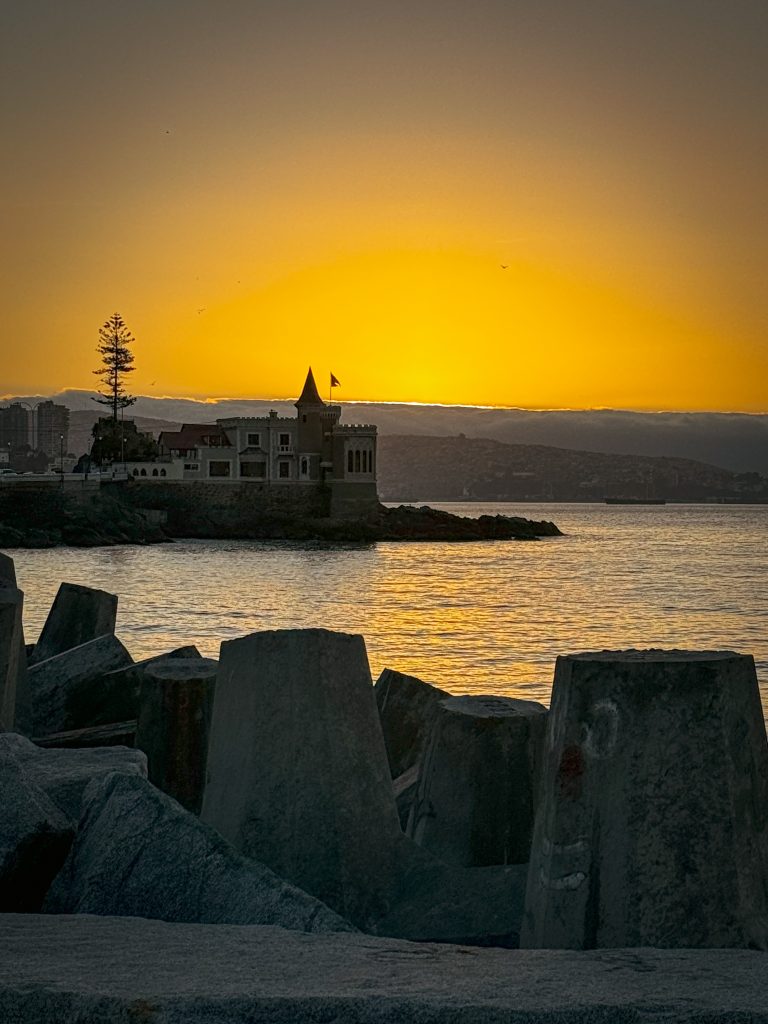 Glowing sky just after sunset featuring Wulff Castle and the sea