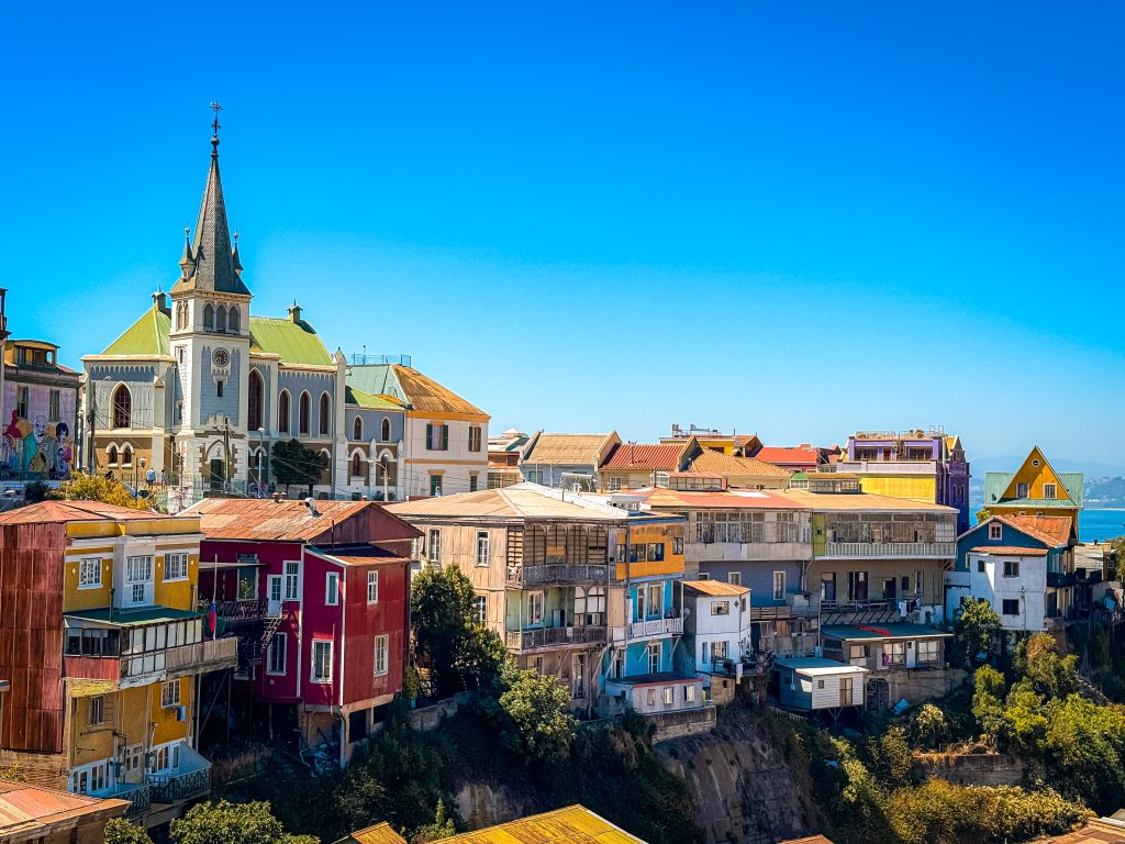 The skyline of colorful buildings, with the sea behind them, as seen from the top of the hills in Valparaiso