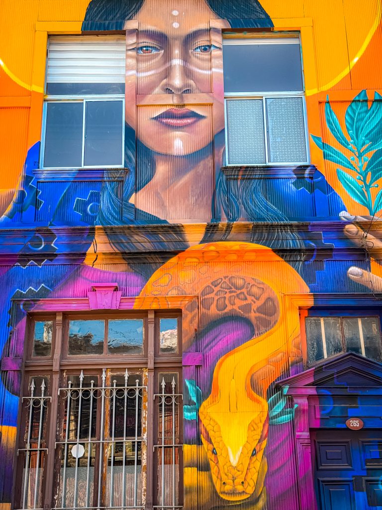 Colorful street art of a woman with a snake in Valparaiso, Chile