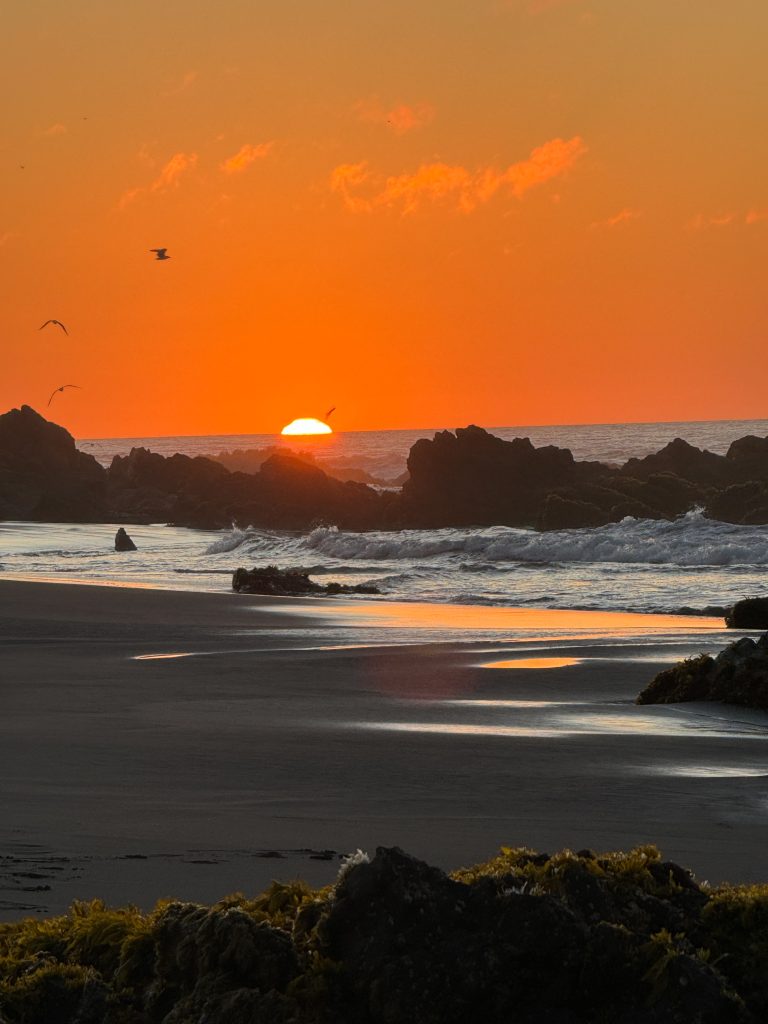 Sunset over the beach and waves in Pichilemu Chile