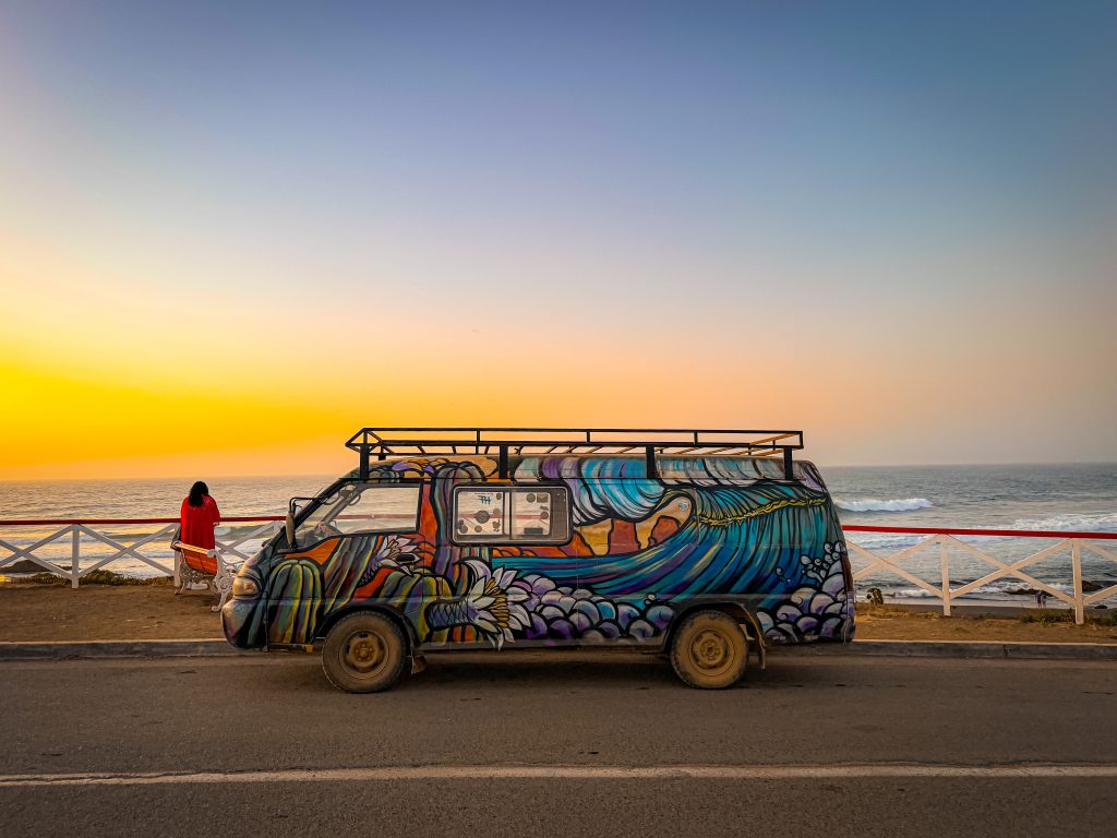 Painted mural bus in front of the ocean in Pichilemu Chile