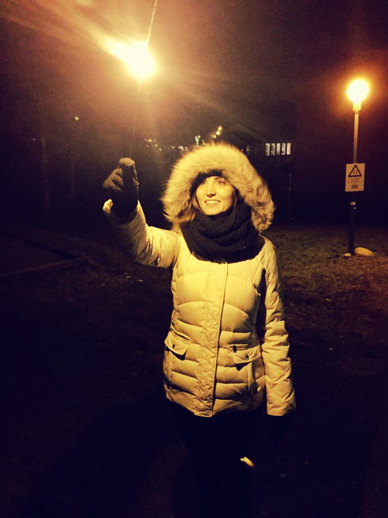 A woman with a sparker lighting up the night for New Year's Eve in Norway