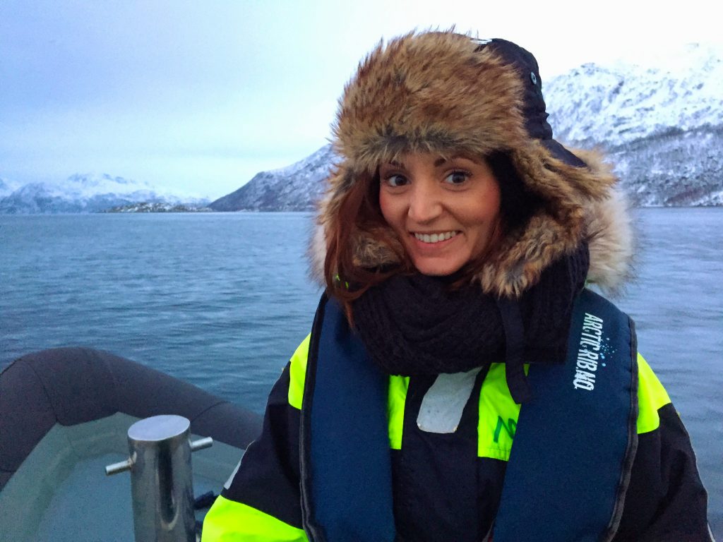 A woman in an arctic suit on a rib boat whale watching tour in Tromso, Norway