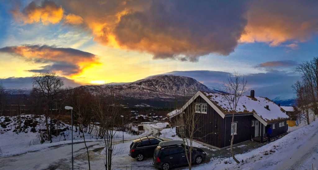 Sunset over snowy mountains behind a cabin in Oppdal, Norway