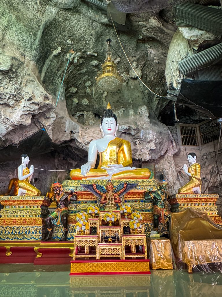 Seated Buddha statue inside the limestone cave at Tiger Cave Temple