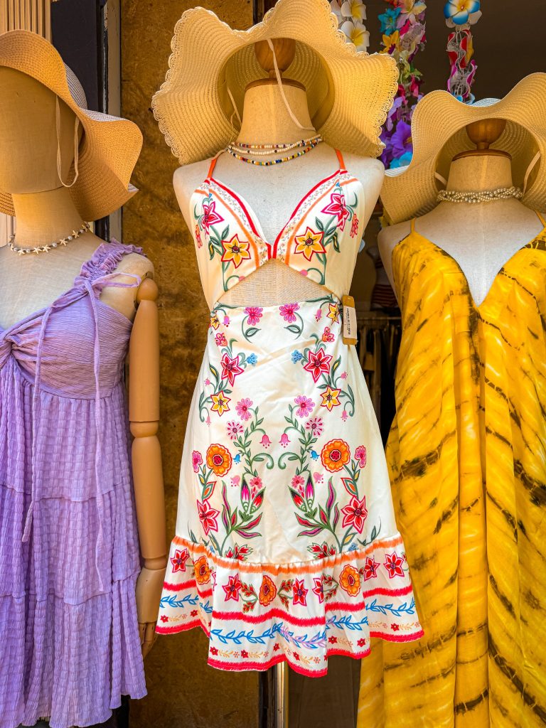 Colorful floral and tie-dye dresses displayed outside a shop on Railay Walking Street.