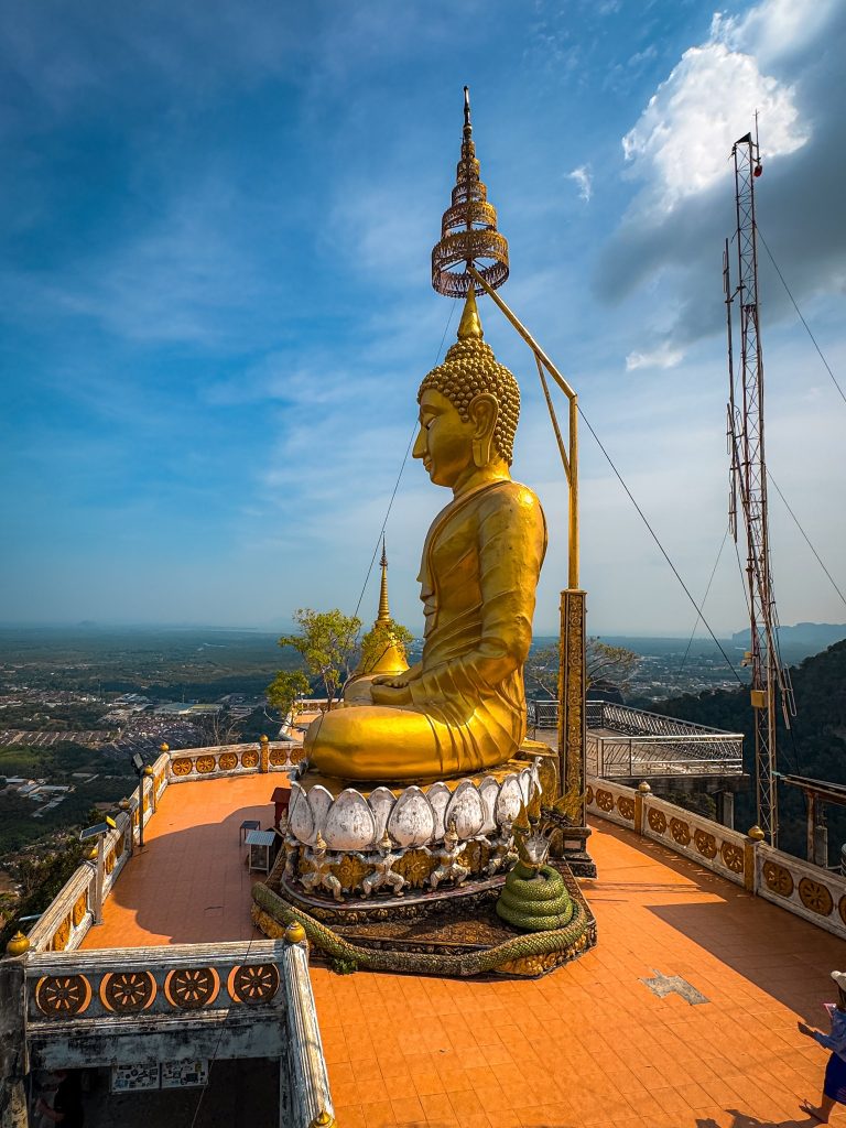 Large golden Buddha statue overlooking Krabi from the Tiger Cave Temple summit