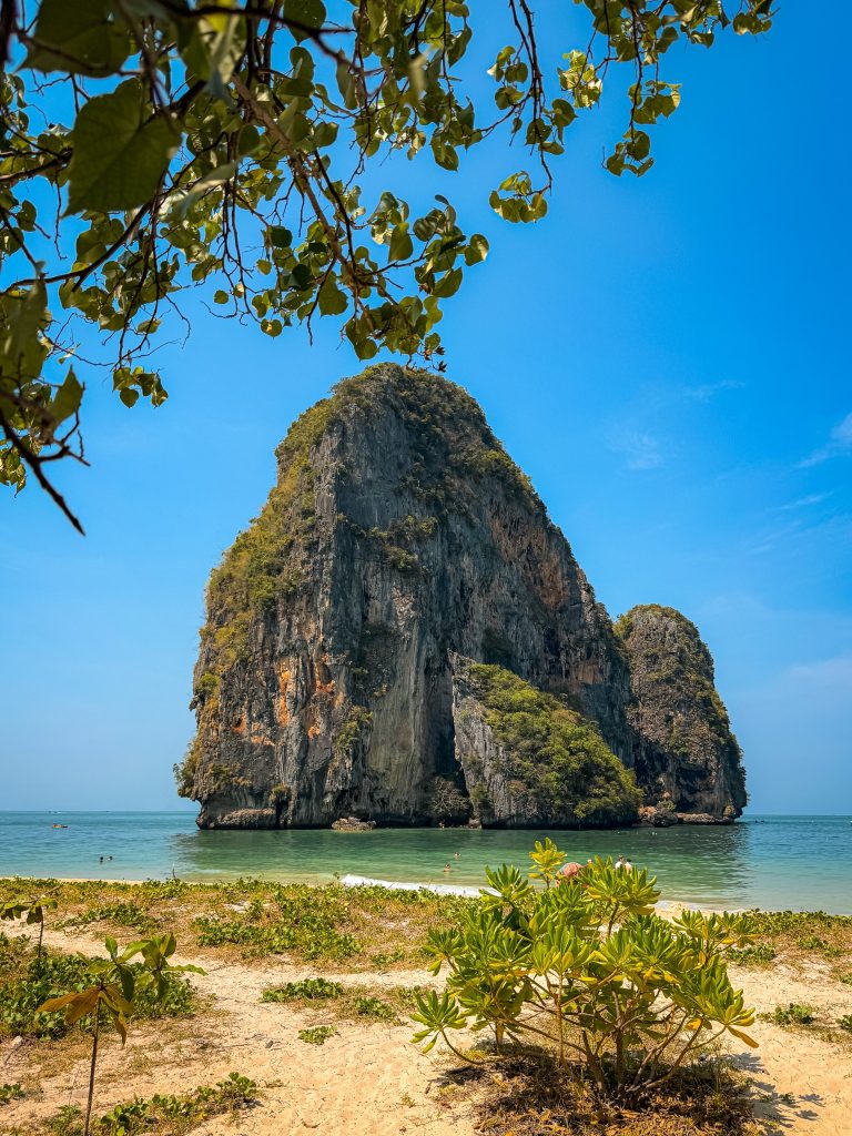 Limestone island rising from turquoise water at Phra Nang Beach in Railay, Thailand.