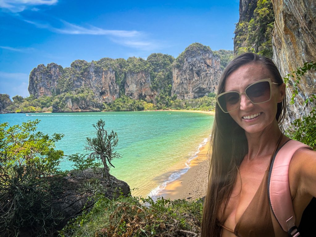 Woman taking a selfie from an elevated viewpoint overlooking Tonsai Beach and limestone cliffs.
