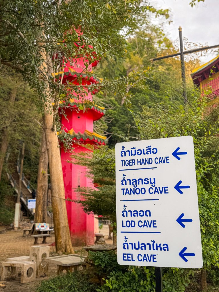 Directional sign for Tiger Hand Cave, Tanoo Cave, Lod Cave, and Eel Cave at Tiger Cave Temple