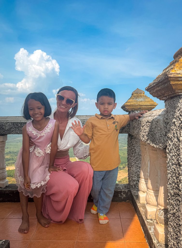 Woman posing with two children at the Tiger Cave Temple summit