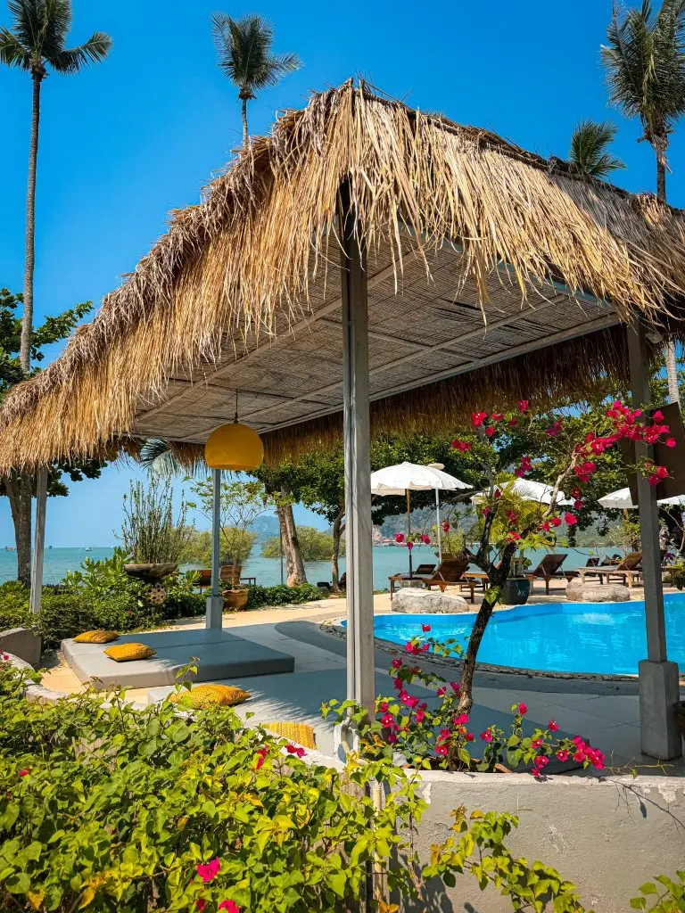 Thatched pool cabana surrounded by bougainvillea at Villa Cha-Cha Krabi Beachfront Resort.