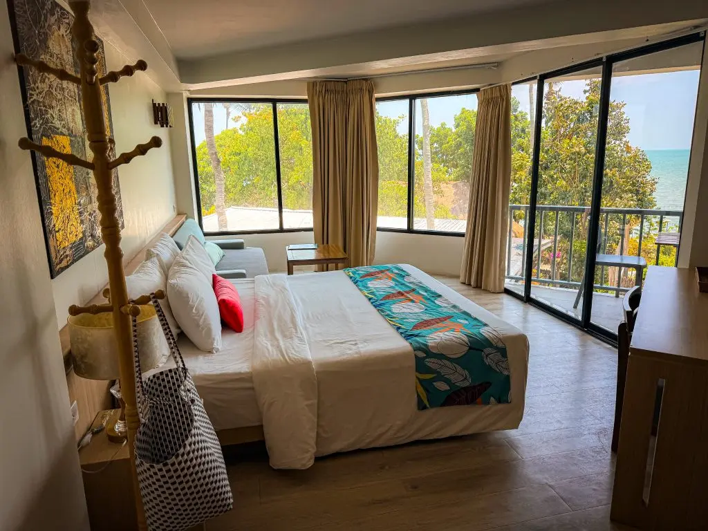 Villa Cha-Cha Krabi guest room with a king bed, balcony, and partial sea view.