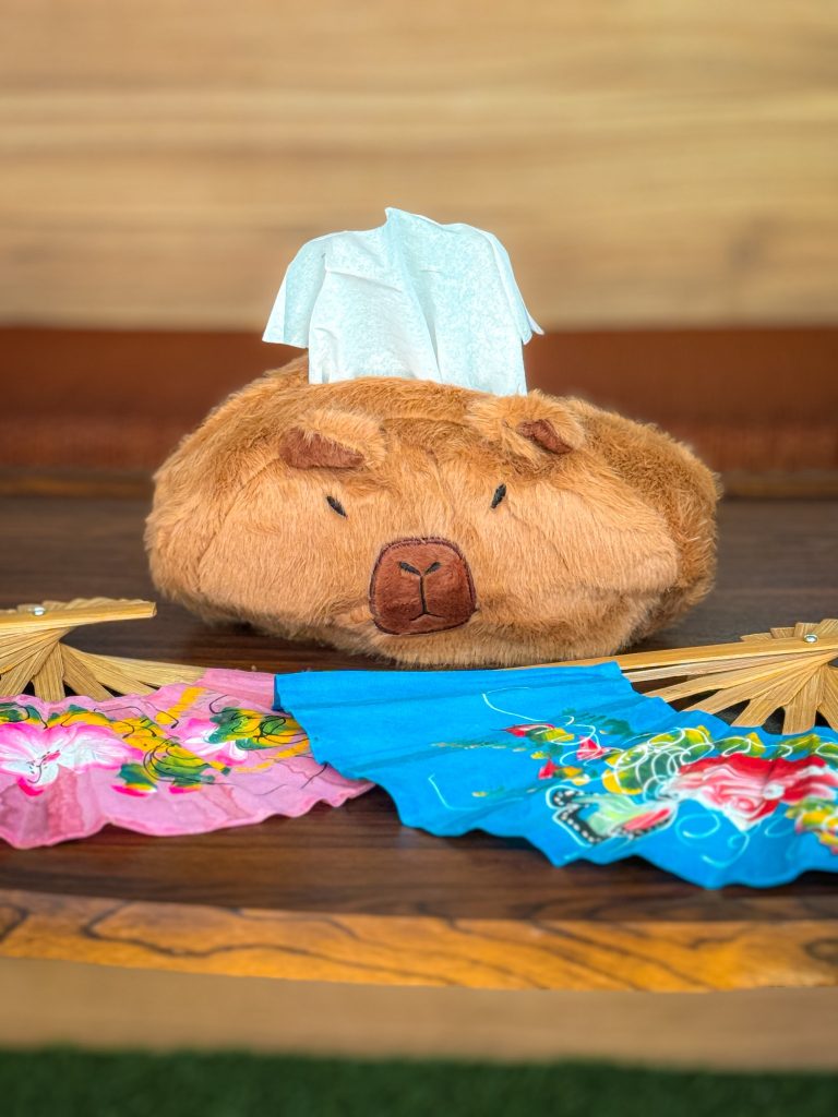 Capybara-shaped tissue box with colorful Thai fans at Capybara Cafe Thailand in Chiang Mai.