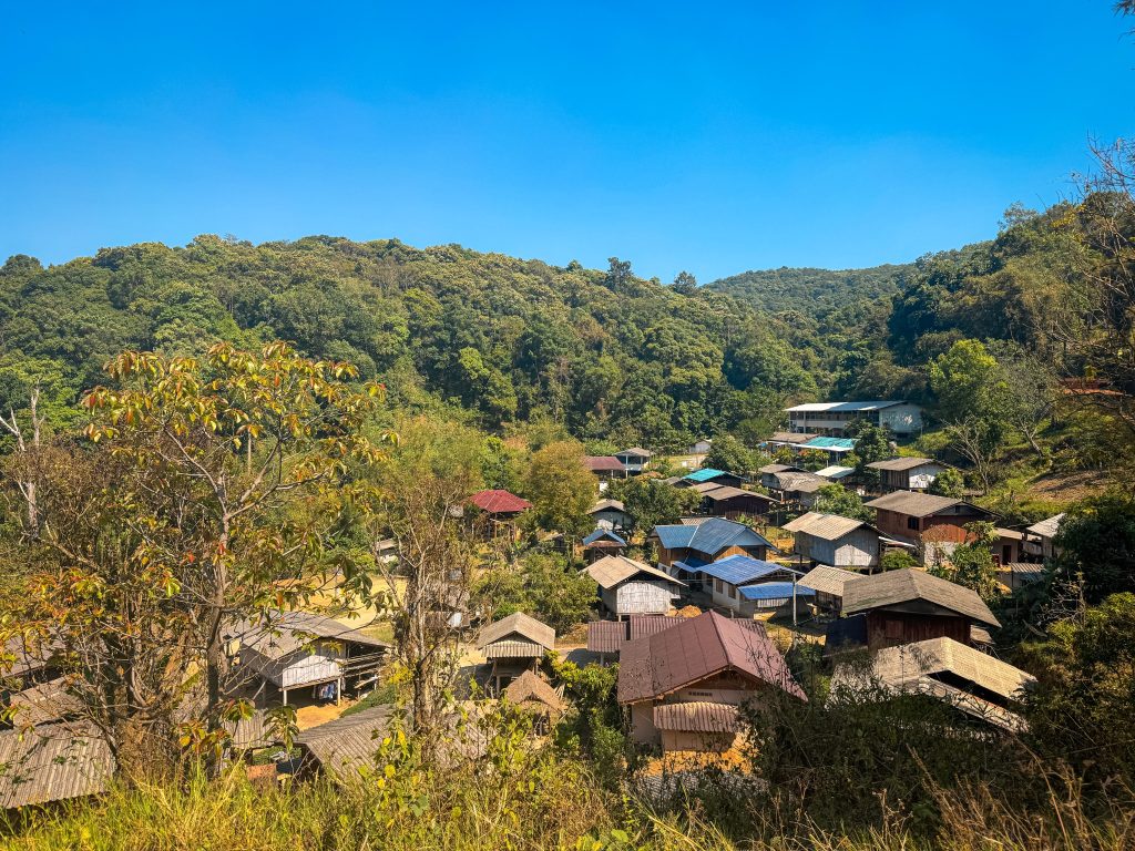 Panoramic view of a Hmong mountain village surrounded by forest near Doi Inthanon National Park.