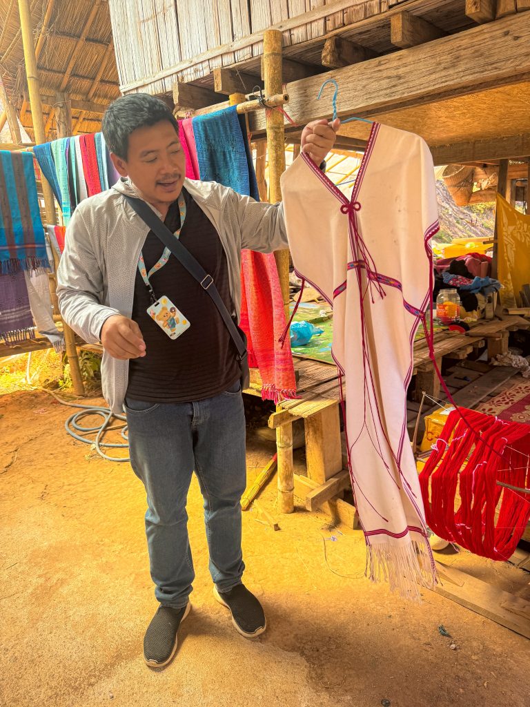 Traditional handmade garment being displayed during a cultural visit to a Hmong village near Doi Inthanon.