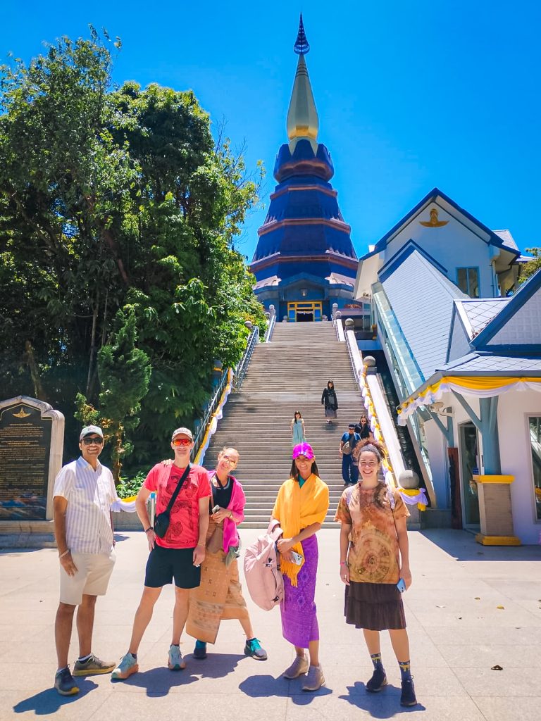 Travelers standing in front of a Royal Pagoda during a Doi Inthanon National Park tour from Chiang Mai.