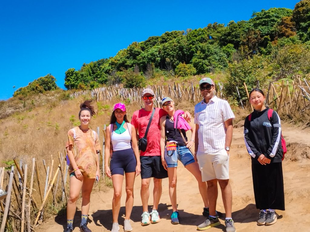 Group of travelers trekking along the Kew Mae Pan Nature Trail in Doi Inthanon National Park, Thailand.