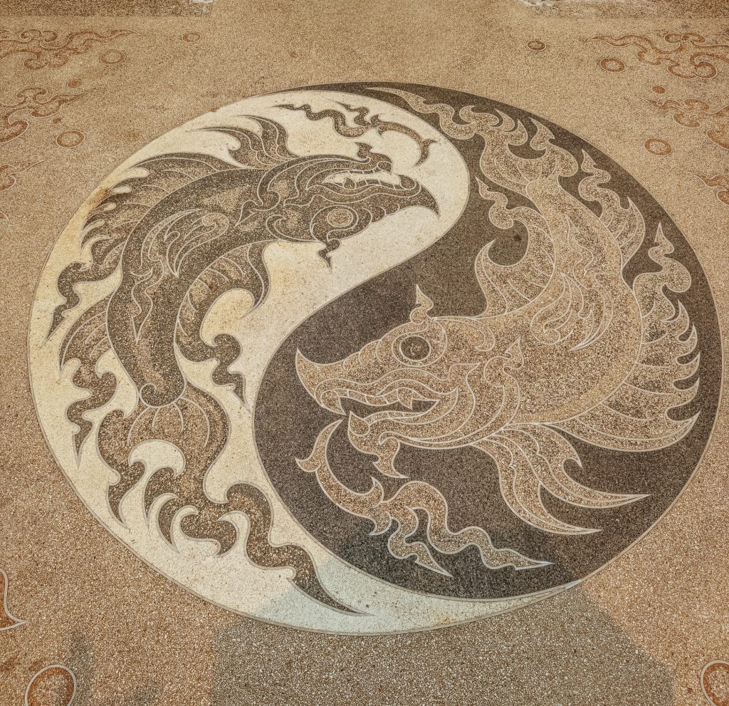 Circular yin-yang style floor design featuring two stylized birds at the White Temple in Chiang Rai.
