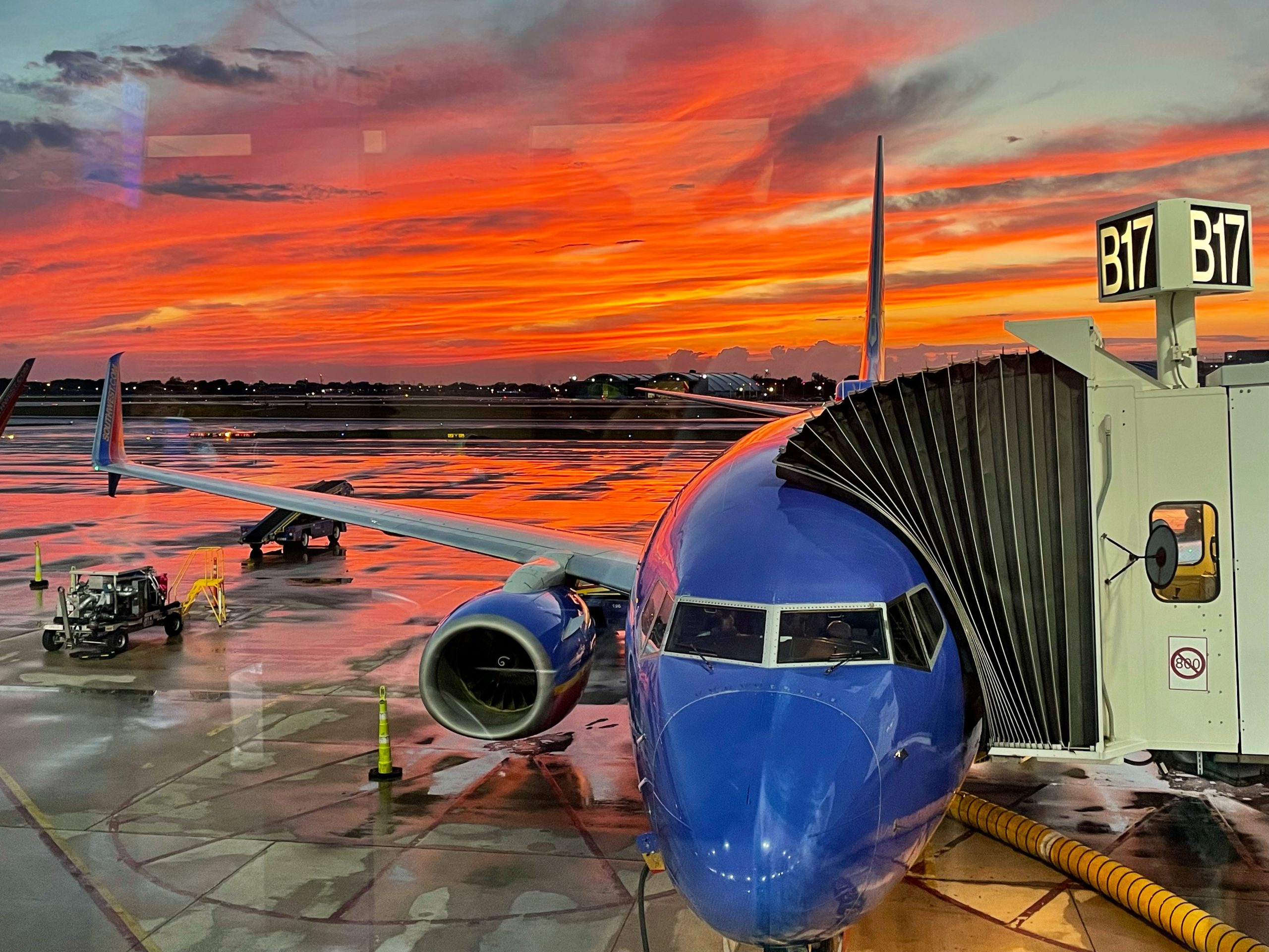 Popular US budget airline plane at jetway in front of sunset