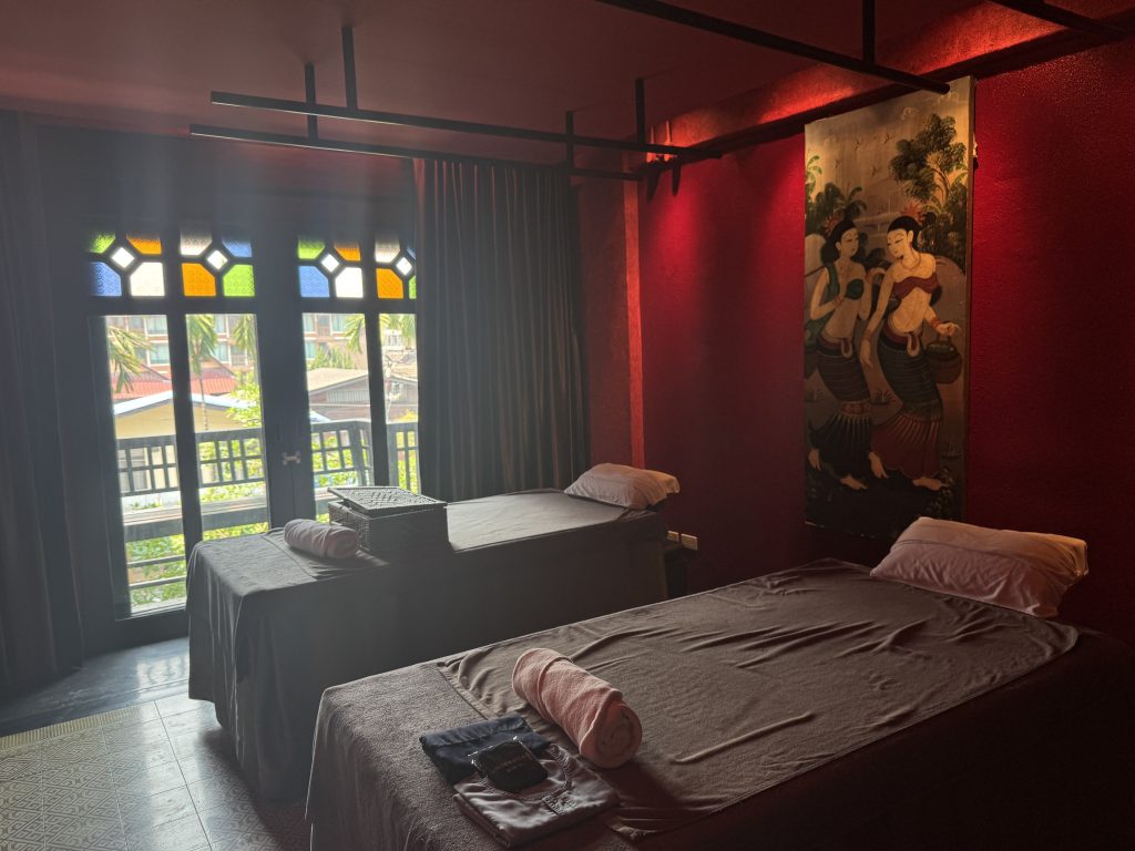 Massage room with two beds and decorative windows