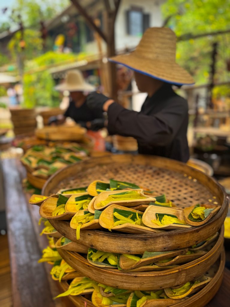 Food being prepared in baskets in open air kitchen in Thailand