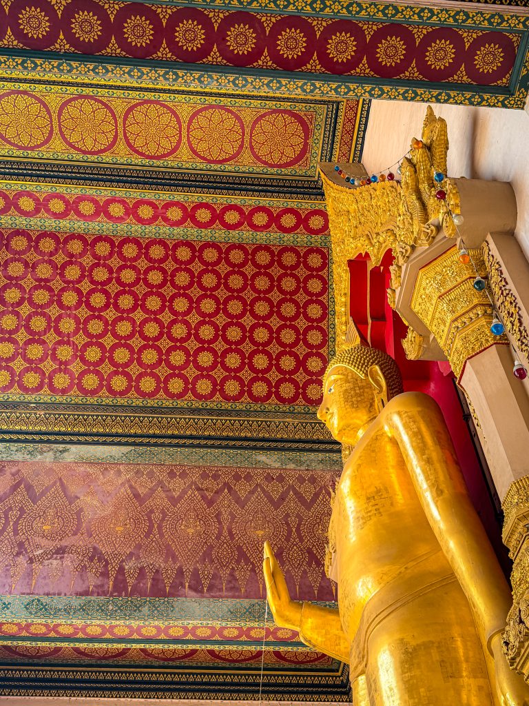 Golden buddha statue in ornante Thai temple