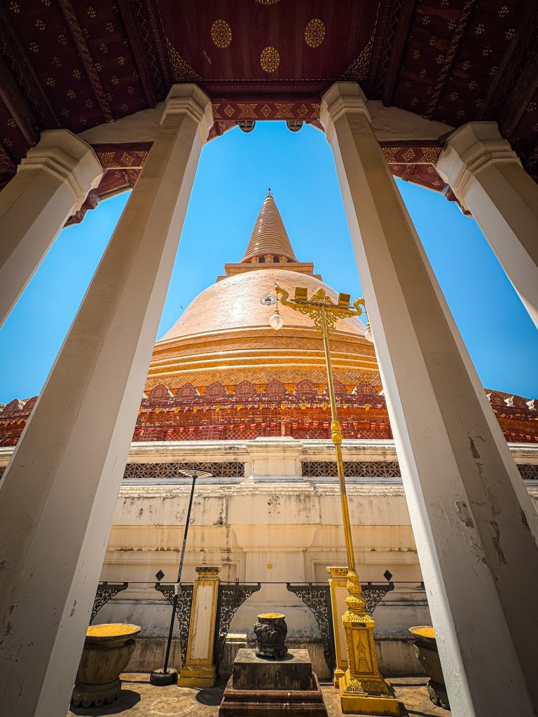 Golden top pagoda between 2 white pillars