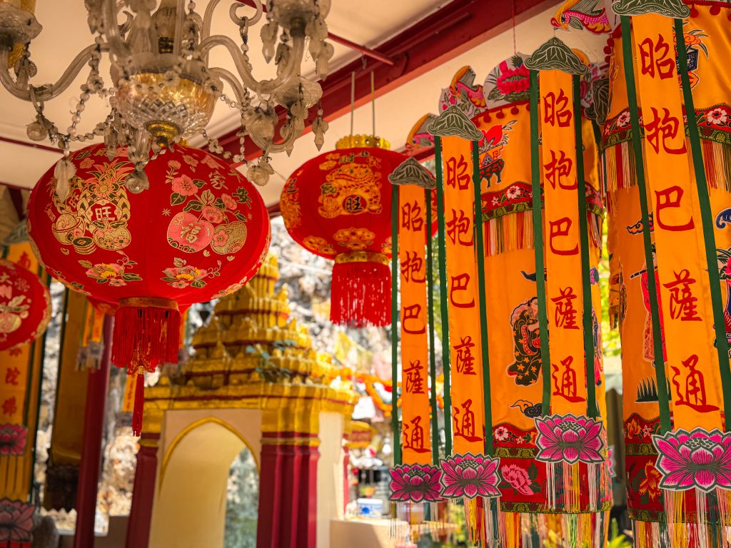 Thai lanterns and colorful ribbons hanging in Thai temple complex