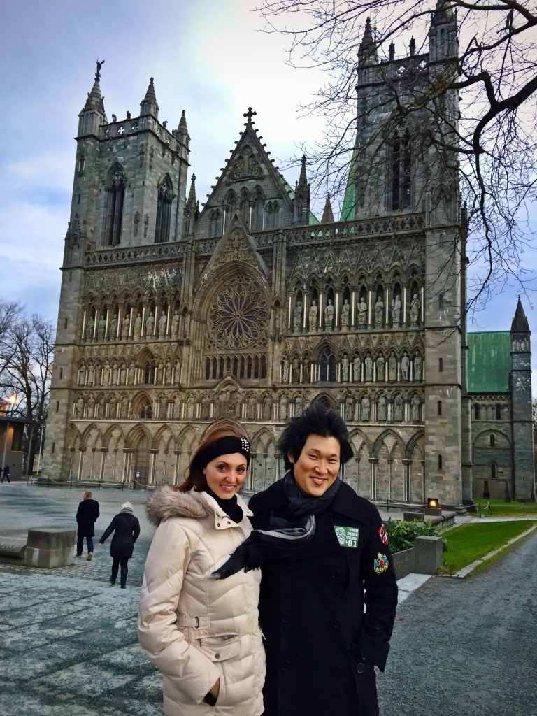 A couple in front of Nidaros Cathedral in winter