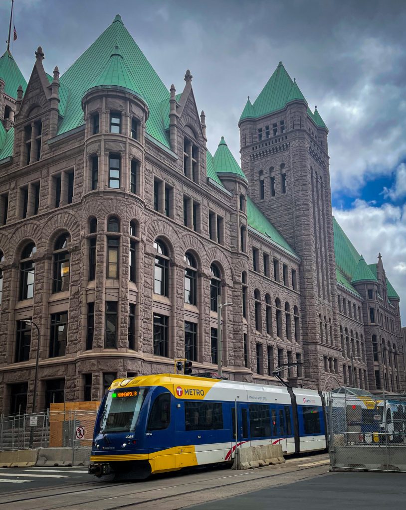 Lightrail metro train in front of ornate building in Minneapolis
