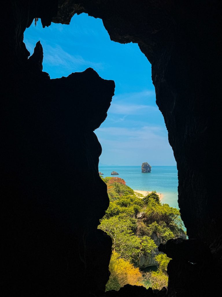 Phra Nang Beach and an offshore limestone island framed by a narrow opening in Bat Cave.
