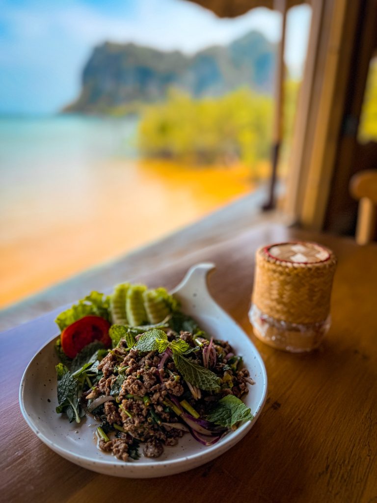 Plate of Thai larb with herbs, vegetables, and sticky rice at Zoluna in Railay.