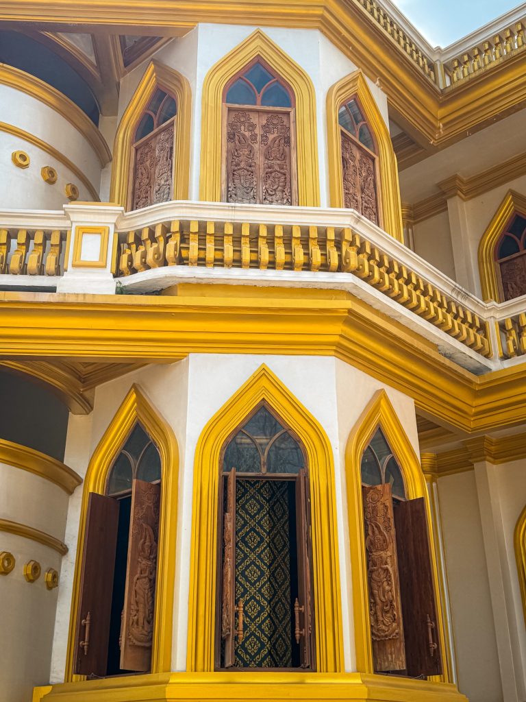Carved wooden windows and gold trim on the Tiger Cave Temple pagoda