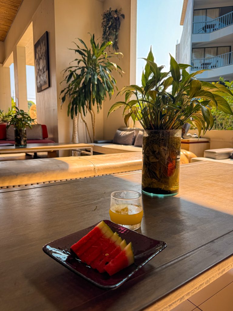 Welcome drink and sliced watermelon served in the open-air lobby at Villa Cha-Cha Krabi.