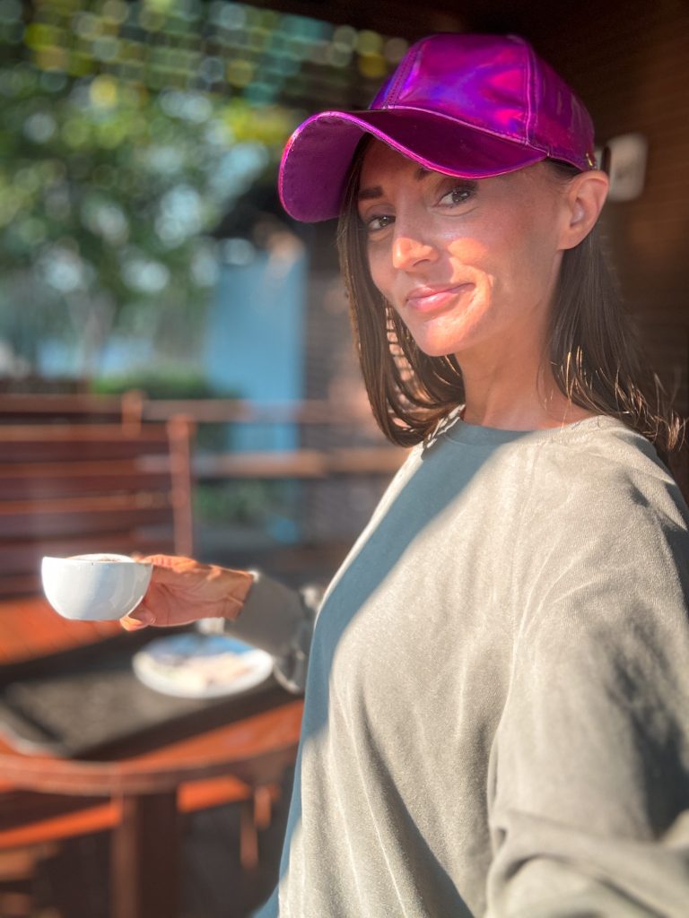 Traveler holding a cup of coffee during a stop on a Doi Inthanon day tour from Chiang Mai.