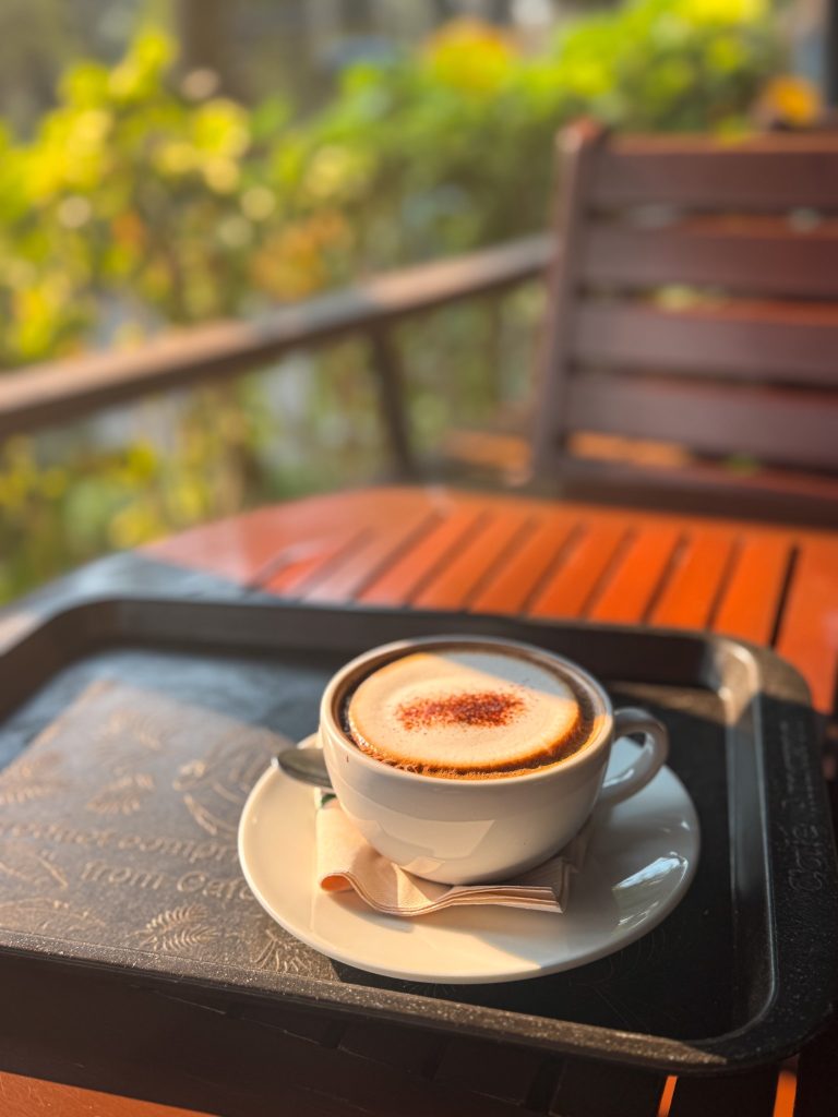 Cup of coffee on an outdoor table during a Doi Inthanon tour in the mountains near Chiang Mai.
