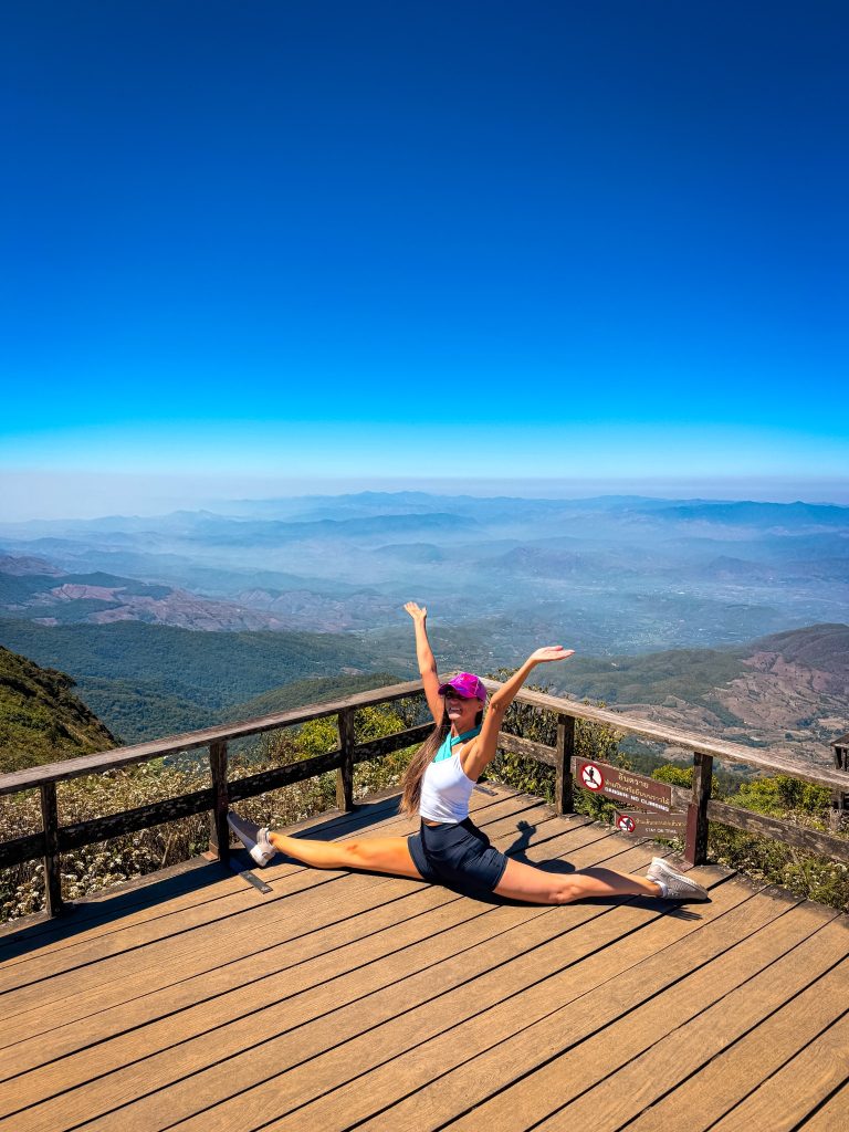 Traveler doing the splits at the Kew Mae Pan Nature Trail viewpoint in Doi Inthanon National Park.